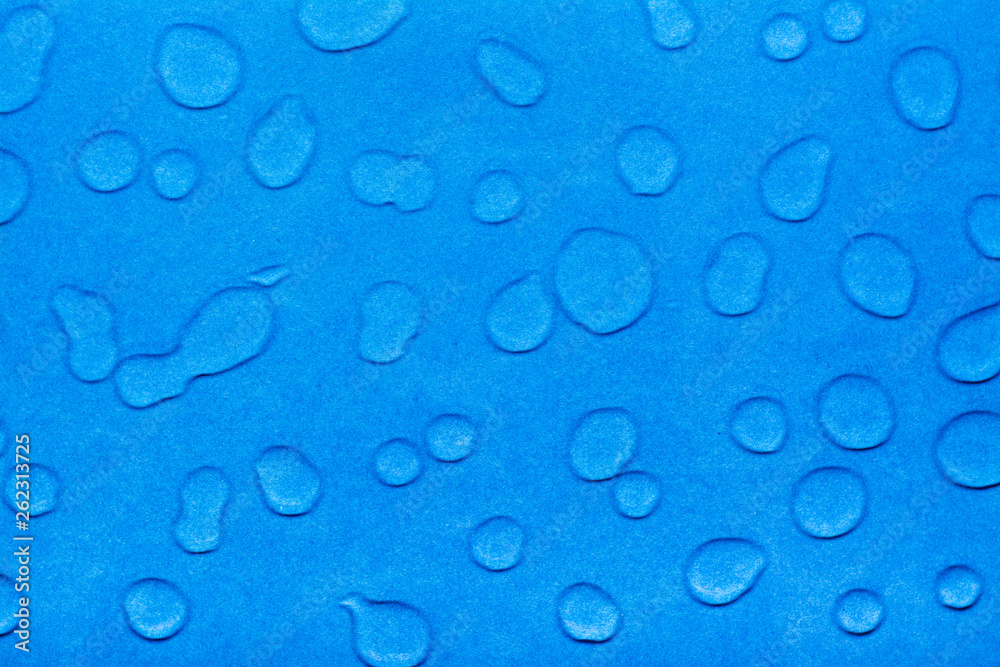 Drops of water on a blue smooth surface. Top view