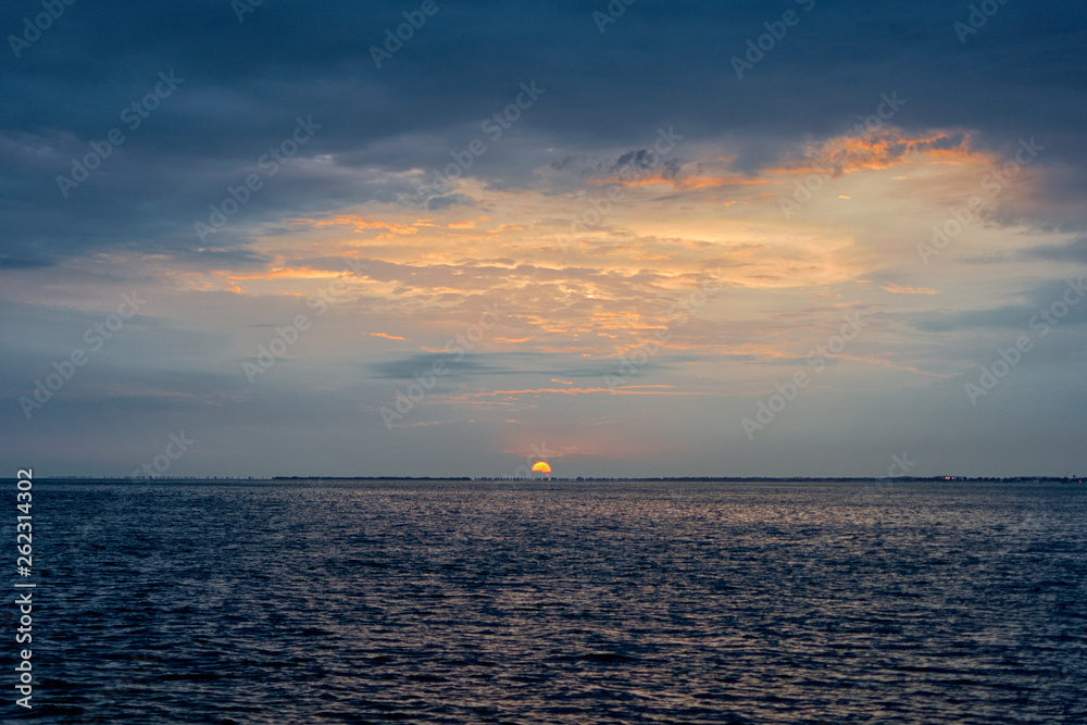 Beautiful sunset over the ocean in a cloudy sky Beautiful sunset over the ocean in a cloudy sky