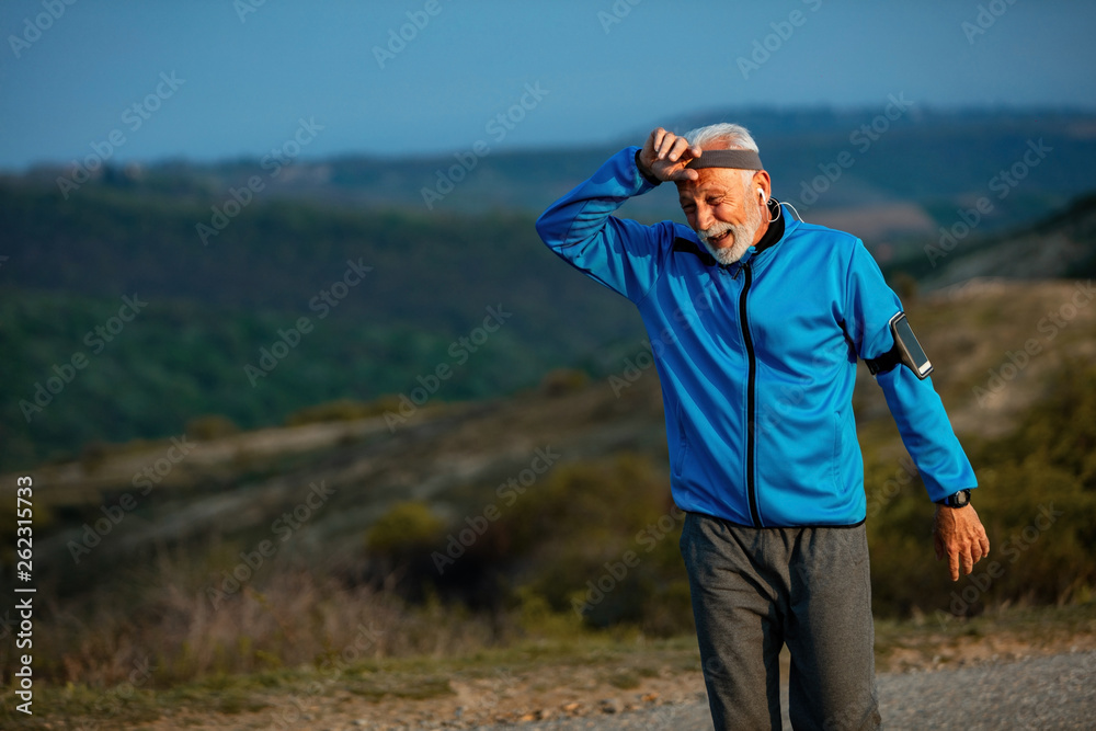 Senior athletic man catching his breath after a run in nature. Senior athletic man catching his breath after a run in nature.