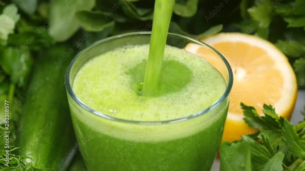 Pouring healthy green cocktail into a glass Pouring healthy green cocktail into a glass