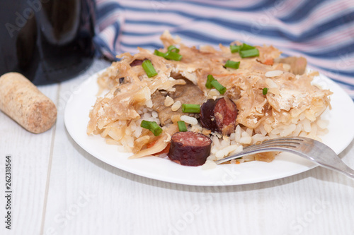 Traditional hungarian food with fried pork, rice, sauerkraut, smoked meat.