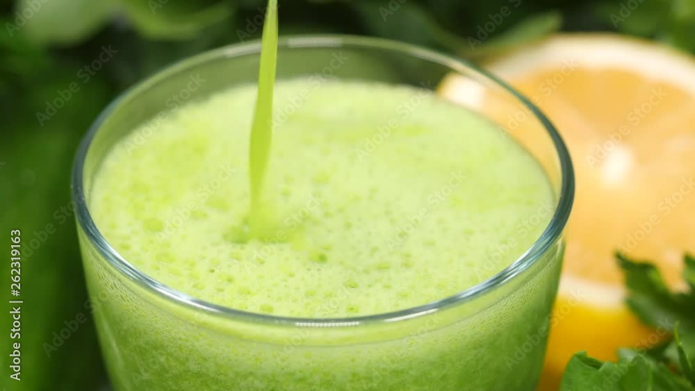 Pouring healthy green cocktail into a glass Pouring healthy green cocktail into a glass
