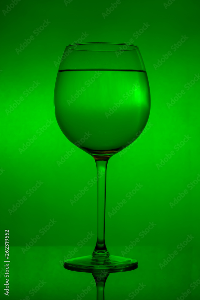 Full wine glass on green background, full wineglass Full wine glass on green background, full wineglass
