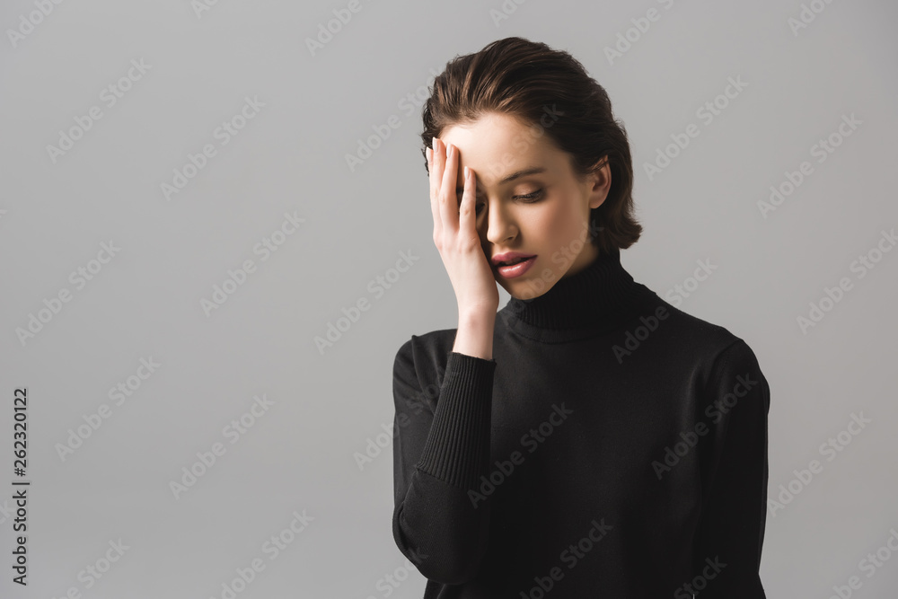 young woman in black jumper covering eye isolated on grey young woman in black jumper covering eye isolated on grey