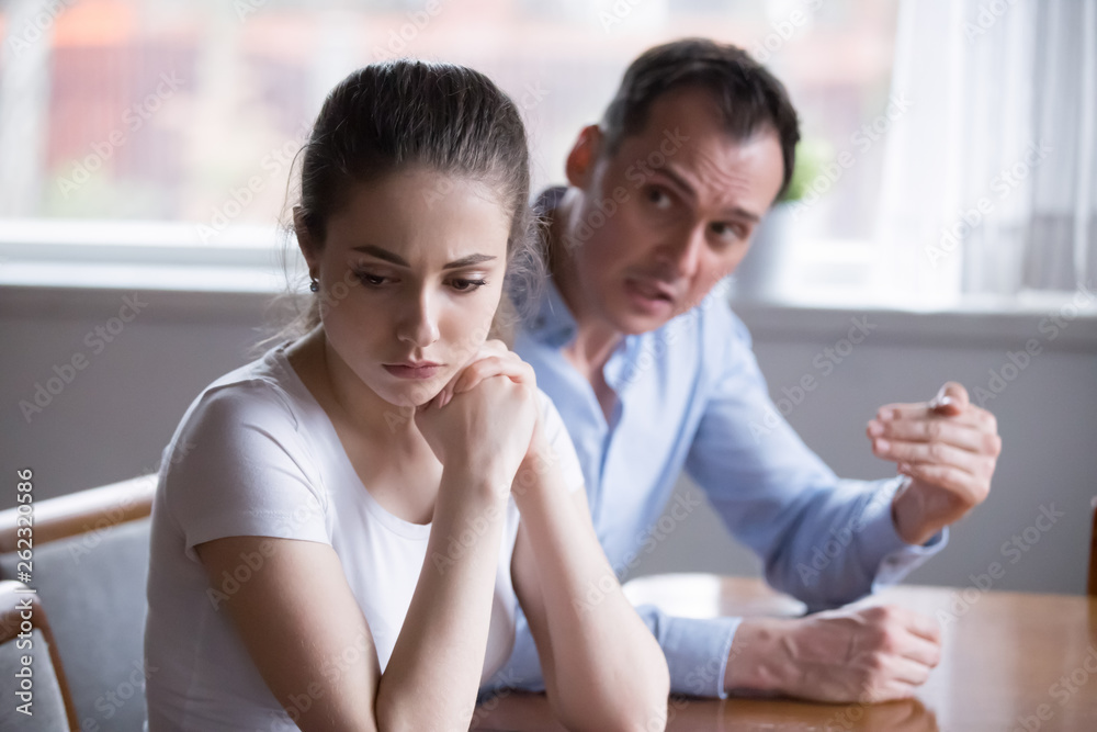 Upset millennial woman turn back on crying angry man Upset millennial woman turn back on crying angry man