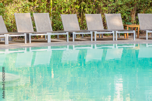 Empty chair around swimming pool in hotel resort