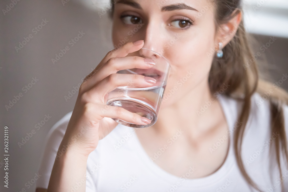 Close up top view woman drinking clear water from glass Close up top view woman drinking clear water from glass