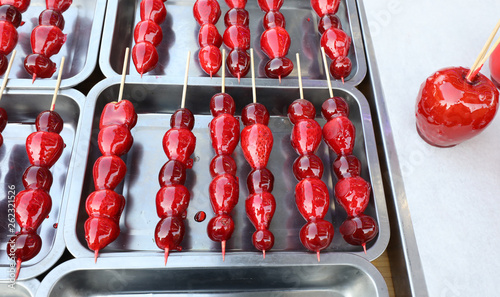 caramelized red apple and strawberries  for sale at kiosk photo