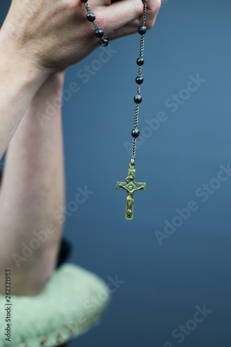 Beautiful rosary. A woman is holding it between her hands.