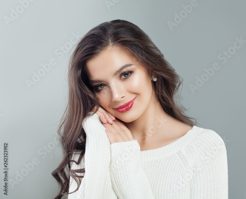 Young beautiful woman smiling. Portrait of pretty model girl with long hair and makeup