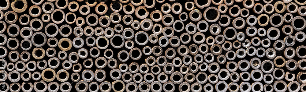 Stacked bamboo twigs close up. Texture of part on bee hive Stacked bamboo twigs close up. Texture of part on bee hive