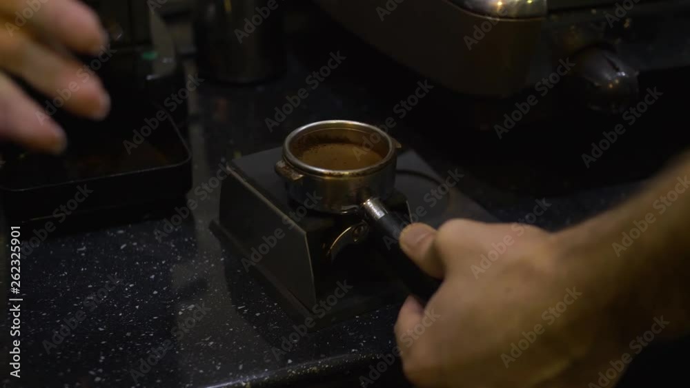 CloseUp. Making Ground Coffee with Tamping fresh coffee. Making coffee