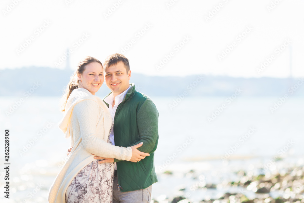 girl and guy hugging and looking at the camera lens on the river girl and guy hugging and looking at the camera lens on the river