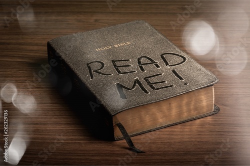 Holy Bible  book with read me letters on a wooden background photo