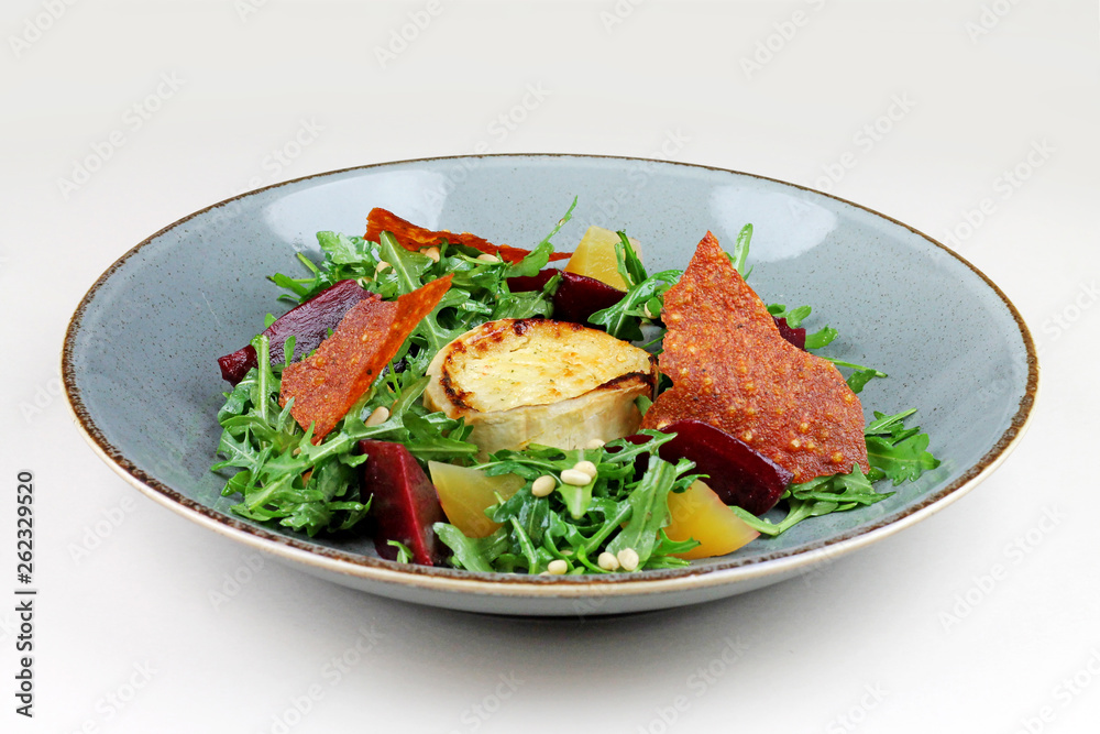 Goat cheese gratinated with rukola, beet and pine nuts. Goat cheese gratinated with rukola, beet and pine nuts.