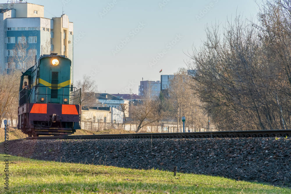 Close-up of a train (locomotive) on rails in the city on a sunny day