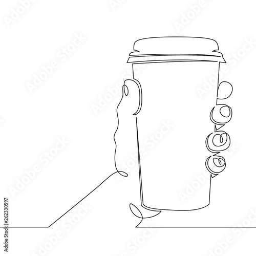 hand holding a glass mug with hot coffee