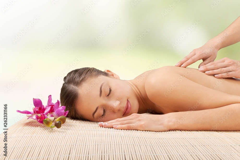 Beautiful young woman relaxing with massage at beauty spa Beautiful young woman relaxing with massage at beauty spa