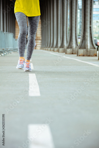 Closeup on woman on Pont de Bir-Hakeim bridge in Paris jogging