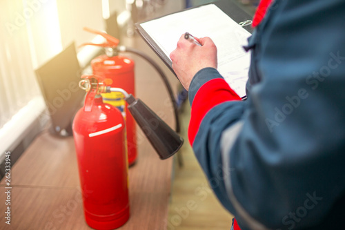 Engineer Professional are Checking A Fire Extinguisher Using Clipboard or checking Industrial fire control system,Fire Alarm controller, Fire notifier, Anti fire.System ready In the event of a fire.