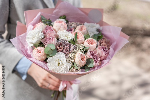 Wallpaper Mural beautiful fresh cut bouquet of mixed flowers in woman hand. the work of the florist at a flower shop. Delicate Pastel tones color Torontodigital.ca