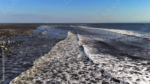 Beautiful 2.7k Slow Motion Drone Over British Coastline Calm Waves Sand and Sun
