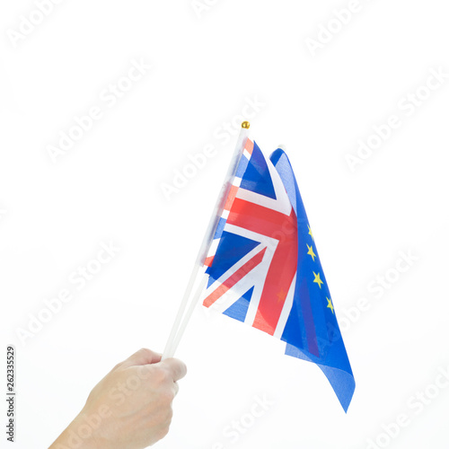Hand holding EU and UK waving flags isolated on white  part of Union Jack visible with copy space. Brexit English language and cooperation concept