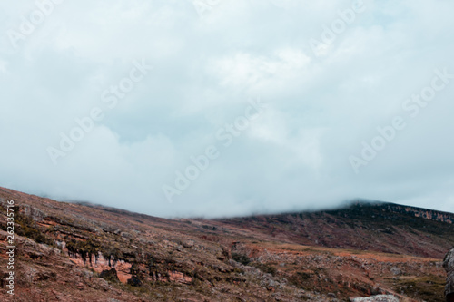 Landscape in Bolivia formed by mountains and white clouds