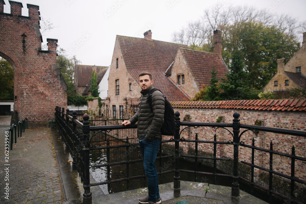 Young man walking in Belgium, Brugge. Male tourist