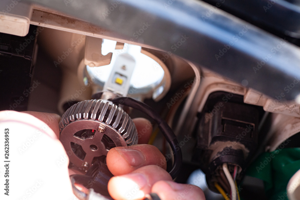 hand installing H7 led headlight bulb with wires. hand installing H7 led headlight bulb with wires.