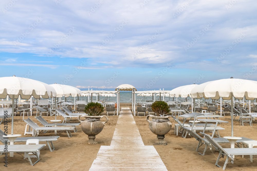 Empty beach with white sunshades against the sky, Italy, Riccione