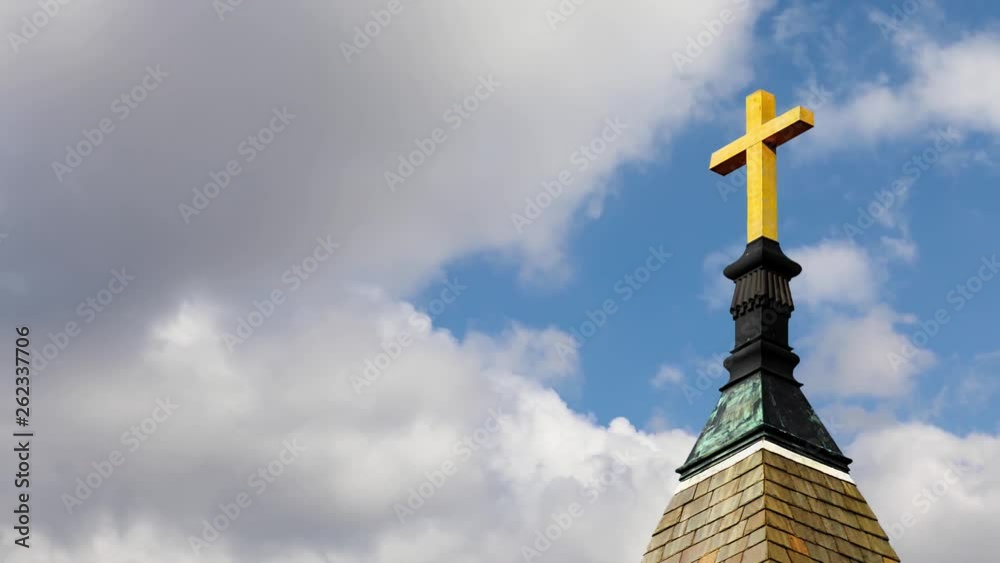 Cross on STeeple Cloud Time Lapse Loop - One minute looping video features a golden cross atop a church steeple with clouds moving at a moderate time lapse rater with a deep blue sky behind. Cross on STeeple Cloud Time Lapse Loop - One minute looping video features a golden cross atop a church steeple with clouds moving at a moderate time lapse rater with a deep blue sky behind.