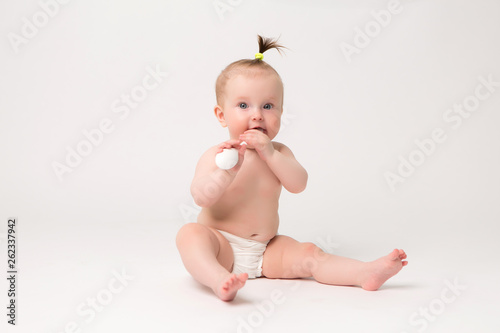 portrait of baby girl smiling 6 months on white background,6 month child baby girl lying happy smiling on a white background