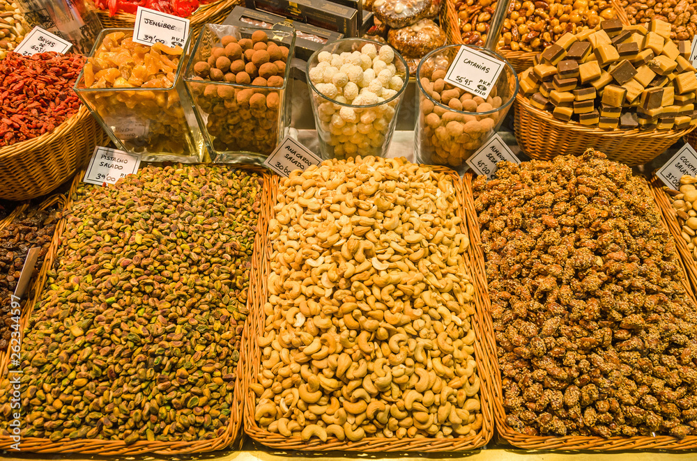 Stall with all kind of nuts, pistachios, cashews, raisins, candies at the market of Barcelona  La Boqueria