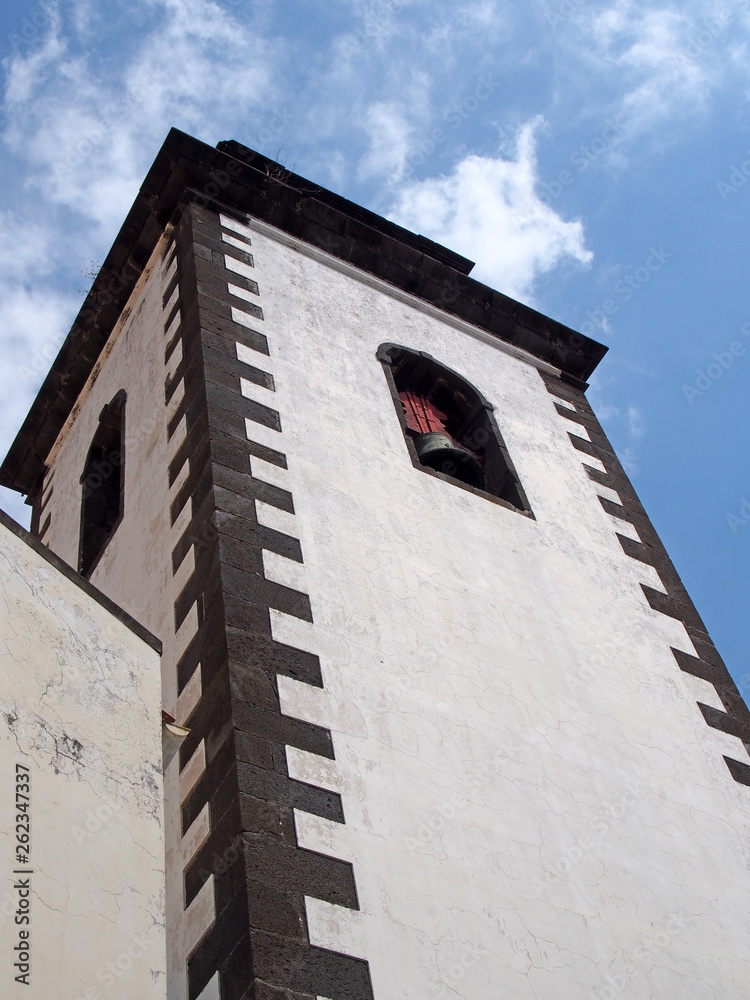 the tower of São Pedro church in funchal a historic 17th century building in madeira notable for the colored tiles on the spire the tower of São Pedro church in funchal a historic 17th century building in madeira notable for the colored tiles on the spire