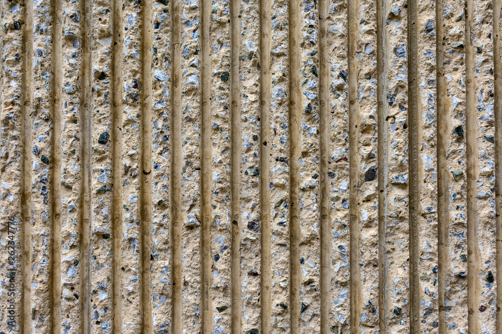 Fototapeta premium Beige concrete wall pattern vertical lines and stripes. Design concept.