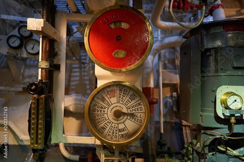 Engine order telegraph to comunicate movement of ship from captain bridge in boiler room of steam powered war ship or batte ship from world war two served in Royal british navy in atlantic ocean. photo