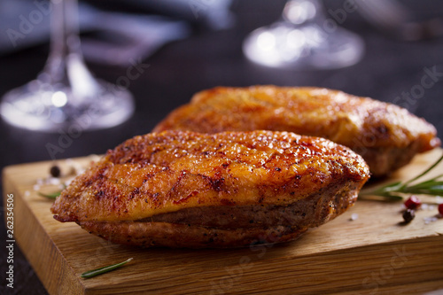 Roasted duck breast on chopping board - image