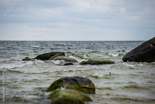 Fototapeta Naklejka Na Ścianę i Meble -  stormy sea beach with large rocks in the wet sand