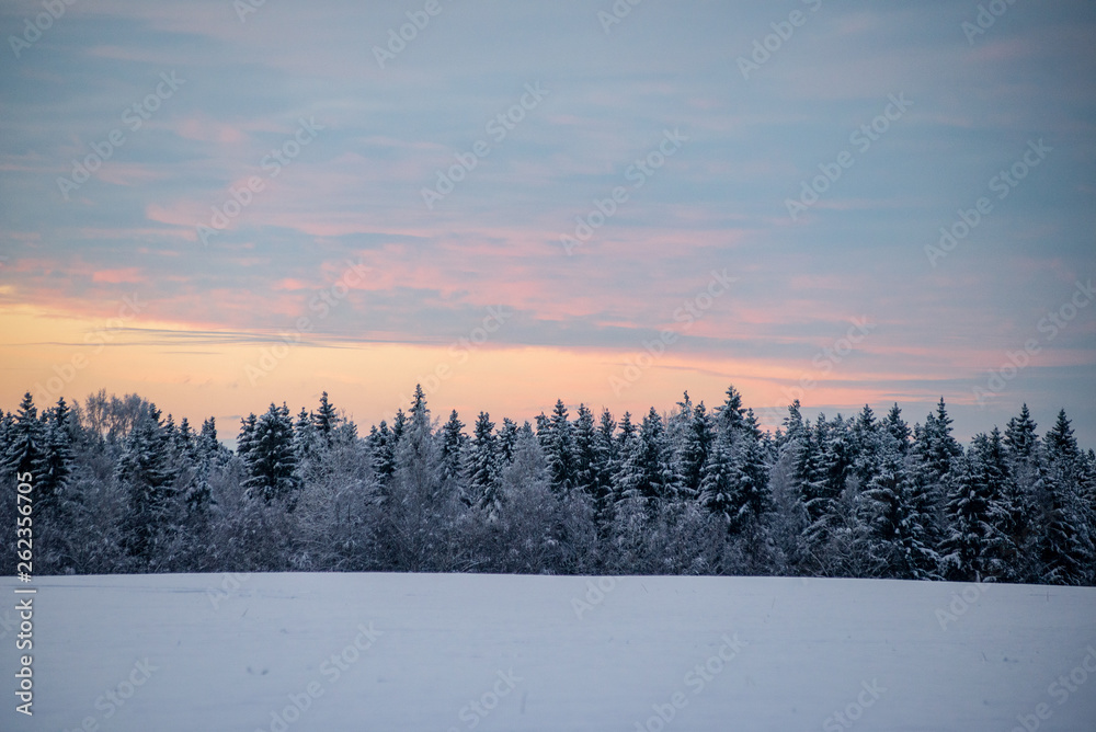 colorful sunset light over fields of snow in winter colorful sunset light over fields of snow in winter