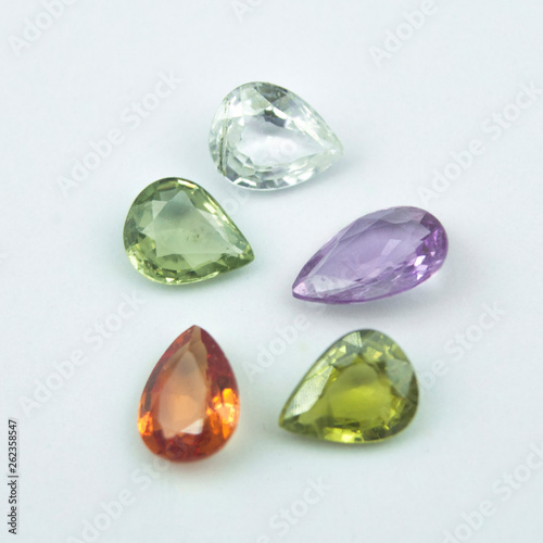 Colorfull natural sapphires in pear shape on the white background