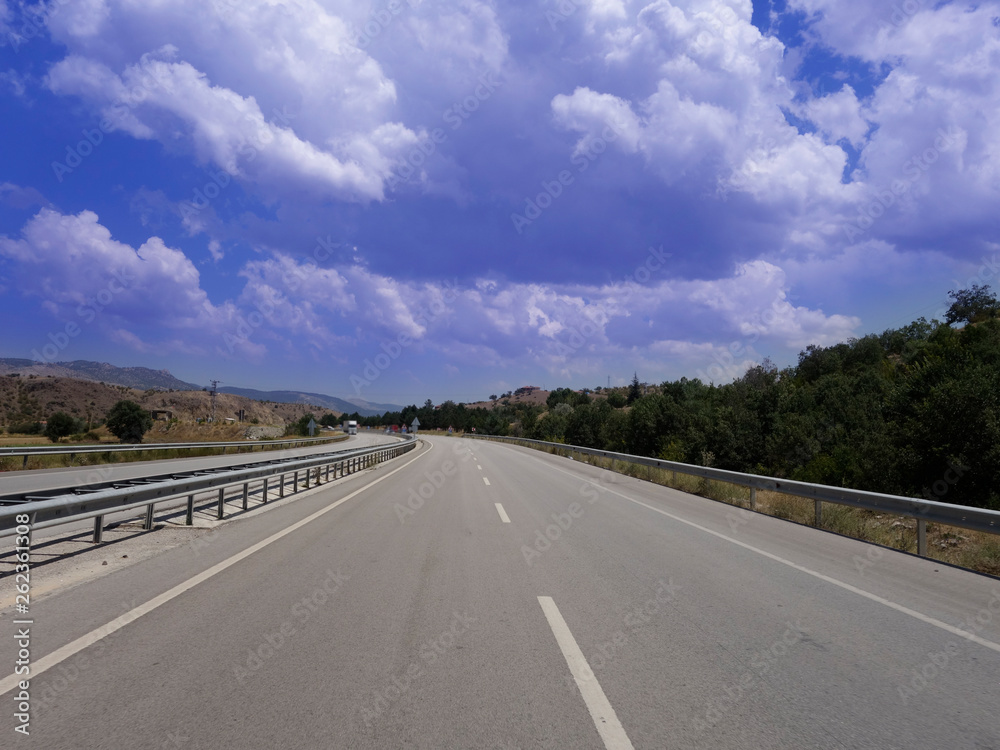 Empty asphalt road to the background blue sky Empty asphalt road to the background blue sky