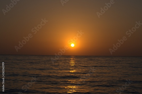 Sunset with large yellow sun under the sea surface © Ulyana