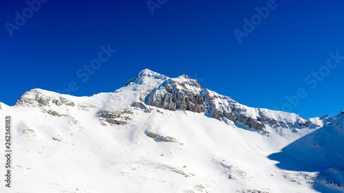 Winter landscape with the mountain peaks covered by heavy snow. Aerial view by drone. 