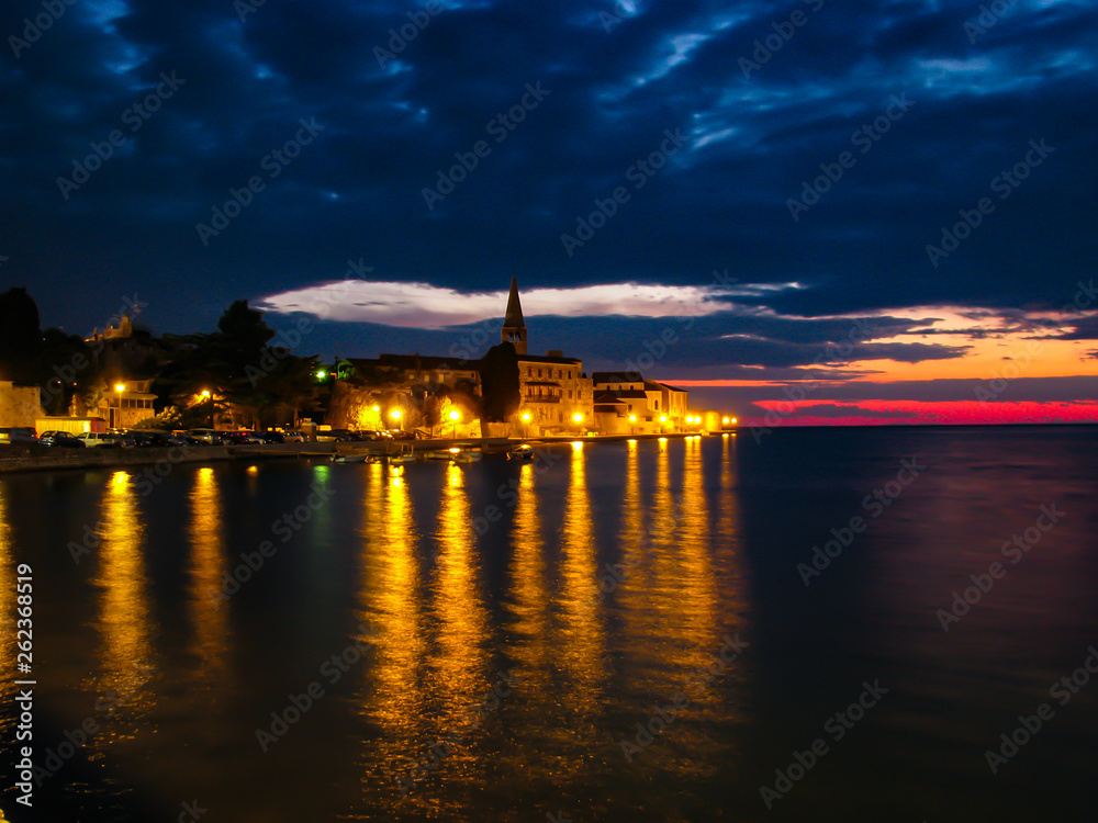Beautiful sunset photo of the city across the sea Beautiful sunset photo of the city across the sea