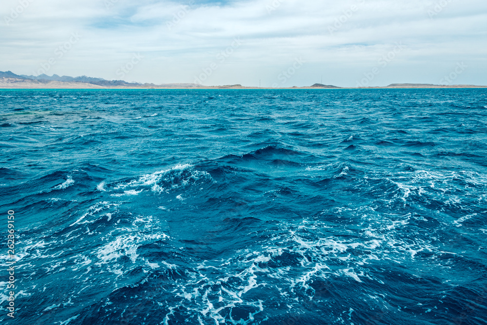 Seascape, view of the blue sea with high bald mountains in the background Seascape, view of the blue sea with high bald mountains in the background