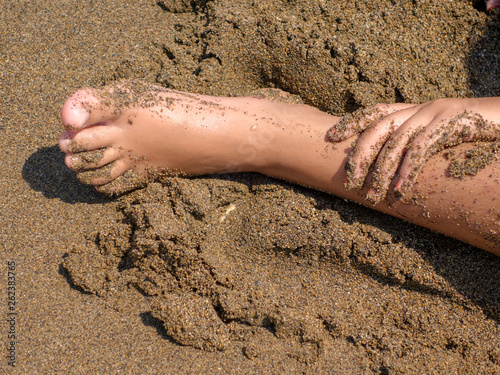 Playing with sand on the beach