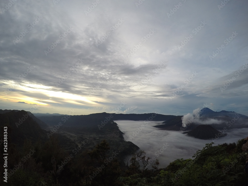 the view on the mountaintop above the clouds. Mount Bromo is an active volcano and one of the most visited tourist attractions in East Java, Indonesia. Panorama Bromo