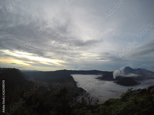 the view on the mountaintop above the clouds. Mount Bromo is an active volcano and one of the most visited tourist attractions in East Java, Indonesia. Panorama Bromo