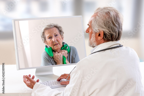 Telemedicine or telehealth concept,Senior Doctor on the computer laptop screen and Senior patient conferencing on treatment for a cold photo